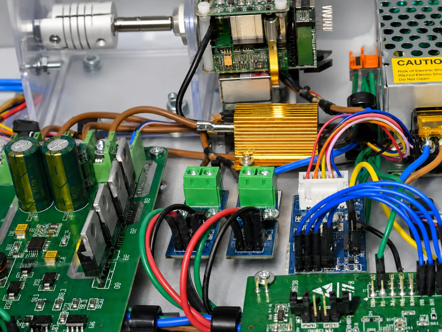 Dense electronic assembly with PCB modules, wiring, connectors, and power components